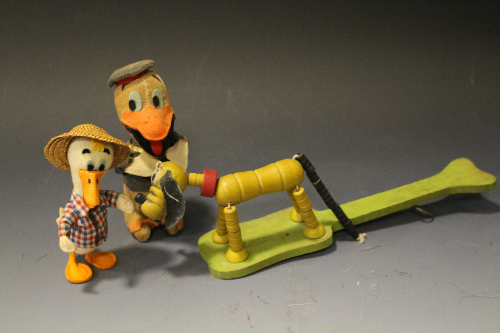 Lot of 3 Toys- Disney, Fisher Price, Other: 1) Walt Disney Productions Woolkin Original Stuffed Donald Duck, 6" H; 2) felt covered duck, no tags; 3) Fisher Price Pluto pop-Up paddle, 11" L.