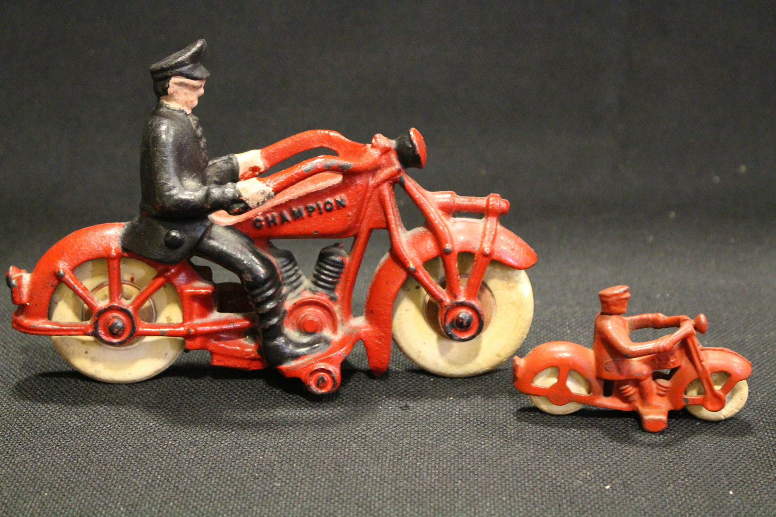 Hubley Champion Motorcycles w/ Policeman: Hubley Embossed "Champion" Motorcycles with Policeman Riders - white rubber tires, 4 1/2" H" x 7 1/4" L.; small version, 3''.