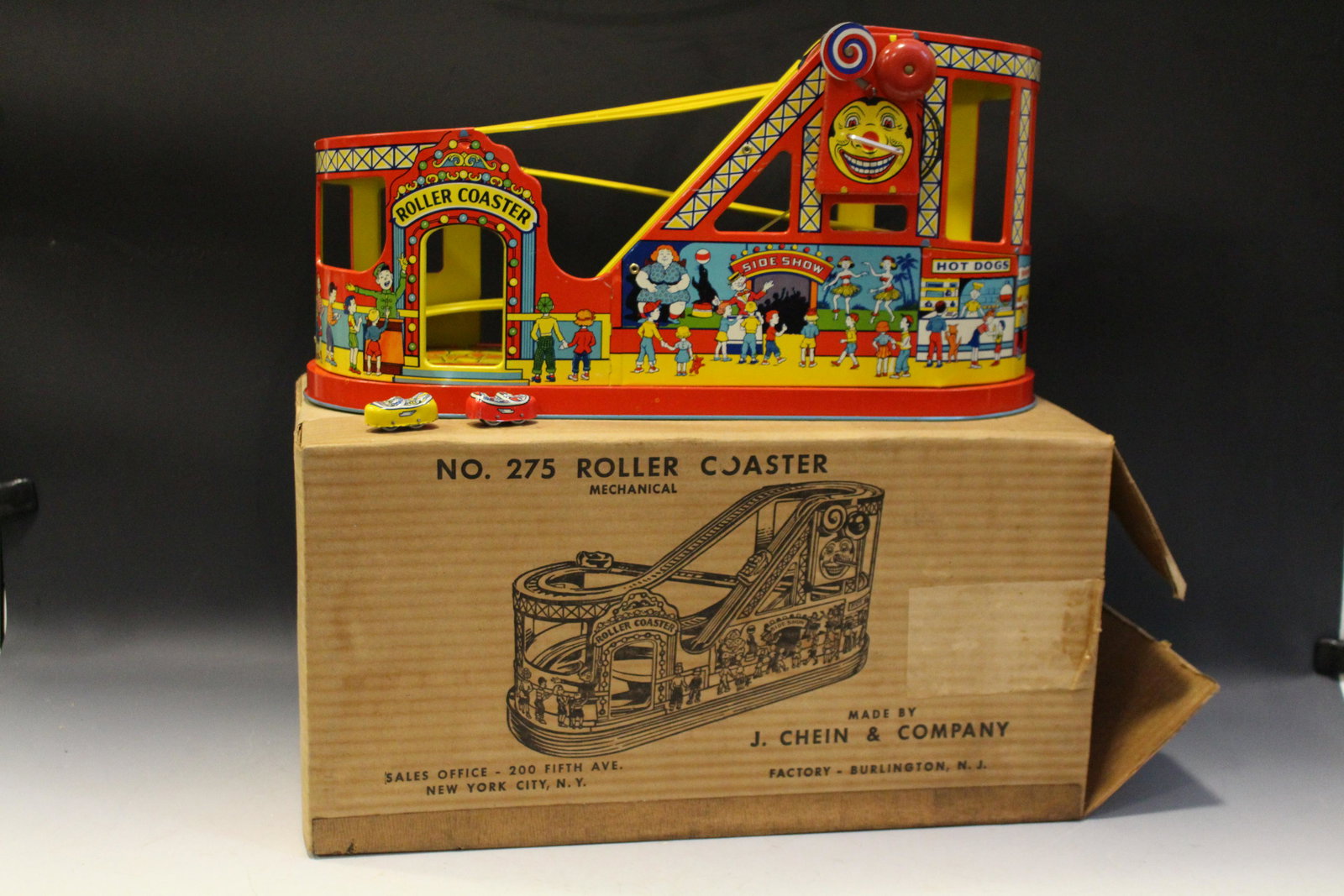 Chein Roller Coaster No. 275 in Original Box: Chein Roller Coaster No. 275 in Original Box, tin wind-up with 2 cars, red bell, working, very good condition, 9 1/2" H x 19" W x 8 1/2" D.