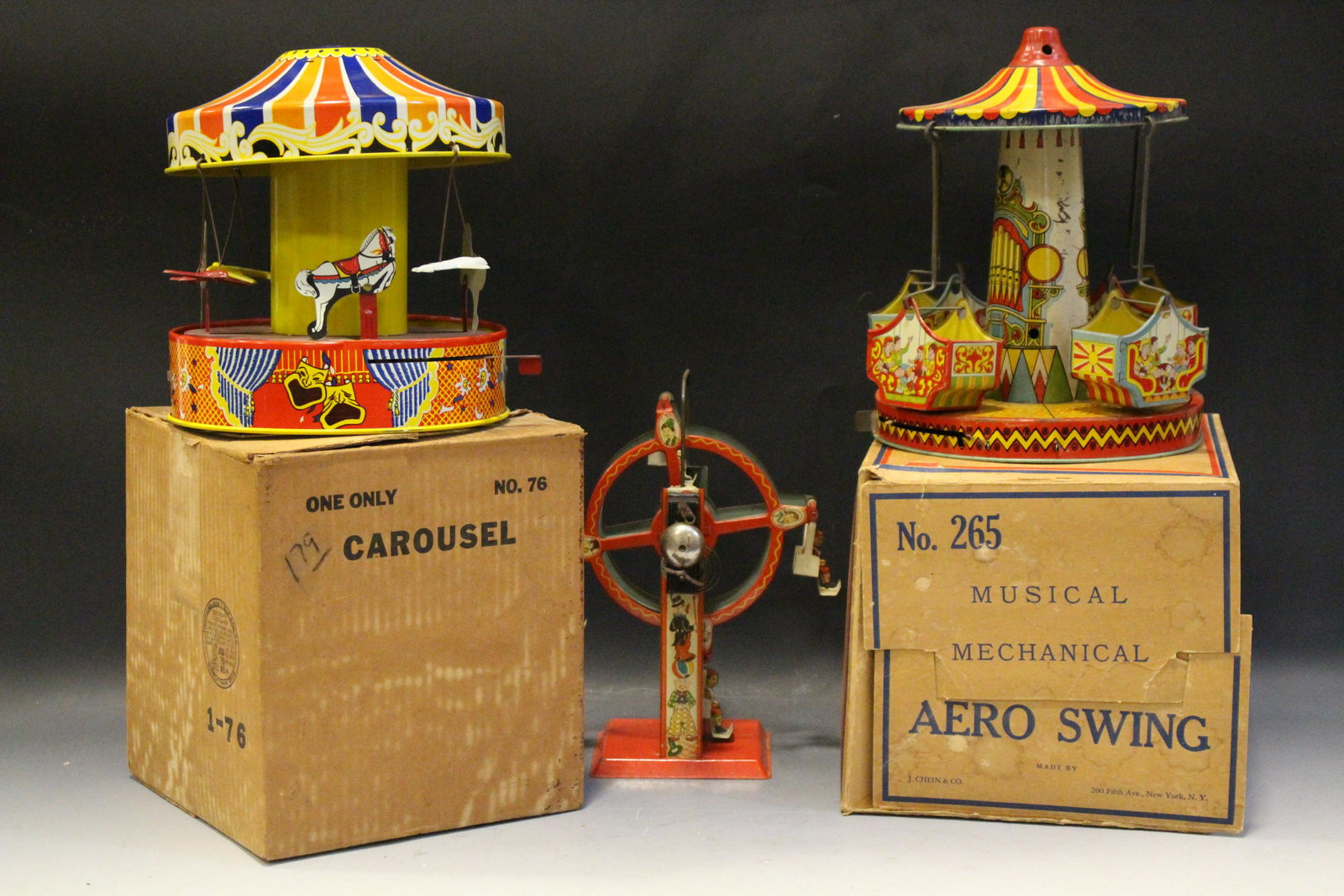 3 Tin Wind-Up Carnival Rides - Two w/ Boxes: Tin Wind-Up Carnival Rides - 1) Chein Musical Aero Swing Tin Lithographed Wind-Up Musical Toy No. 265 - original box, spring is there but lacking slide start-up lever; 2) No. 76 Airplane & Horses Caro