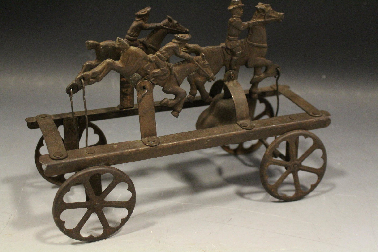 Watrous Roosevelt Rough Riders Bell Pull Toy: Watrous Teddy Roosevelt and His Rough Riders Bell Pull Toy - embossed sheet metal, animated three horses gallop when pulled and bell rings, 9 3/4'' L.