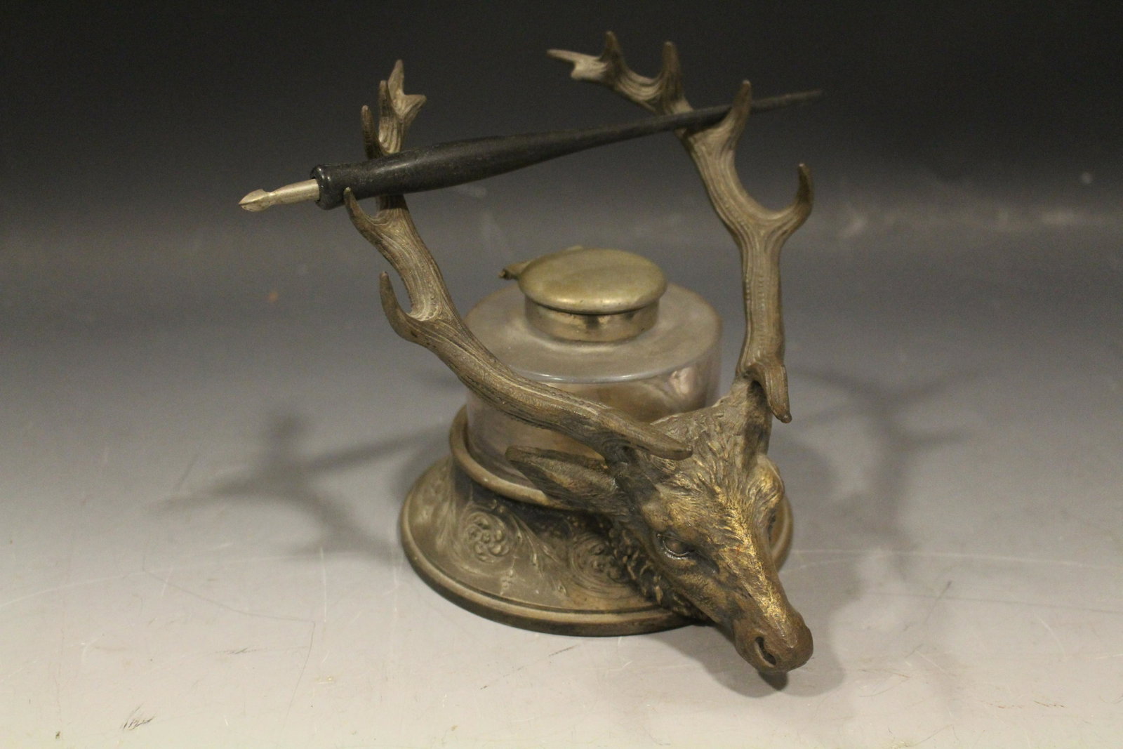 Reed & Barton Elk Head Ink Well: Reed & Barton Silverplated Inkwell, figural elk head, antlers serve as pen holders, original lidded glass jar with no damage, silver plate worn, 5 1/2'' H x 5 1/2'' W.