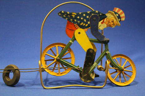 1920 AC Gilbert Uncle Sam Bicycle Balance Toy: 1920s A.C. Gilbert Co lithographed tin bicycle balance toy of Uncle Sam, ridged spoke wheels made to ride and balance toy on string / wire, articulated wheel mechanism makes his legs appear to be peda