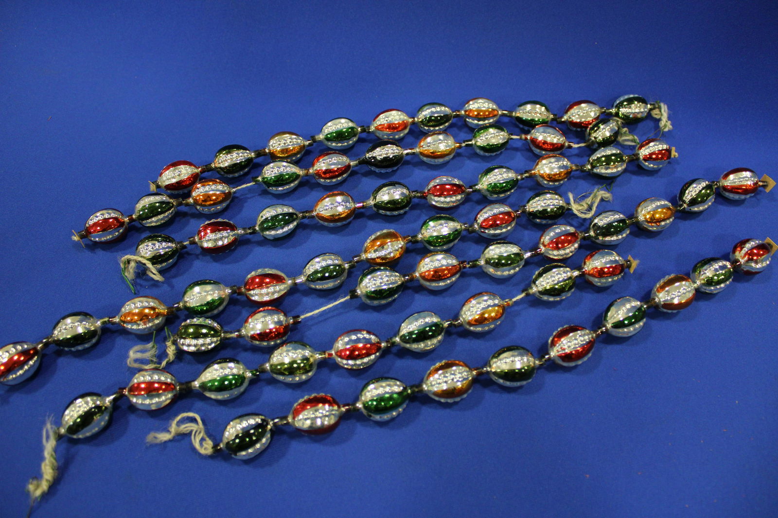 Antique Blown Glass Christmas Tree Garland: Blown Glass Christmas Tree Garland - oval-shaped, apprimately 70 multi-colored blown glass and painted lantern-shaped bulbs. 7 strings total, each about 15 to 17" L.