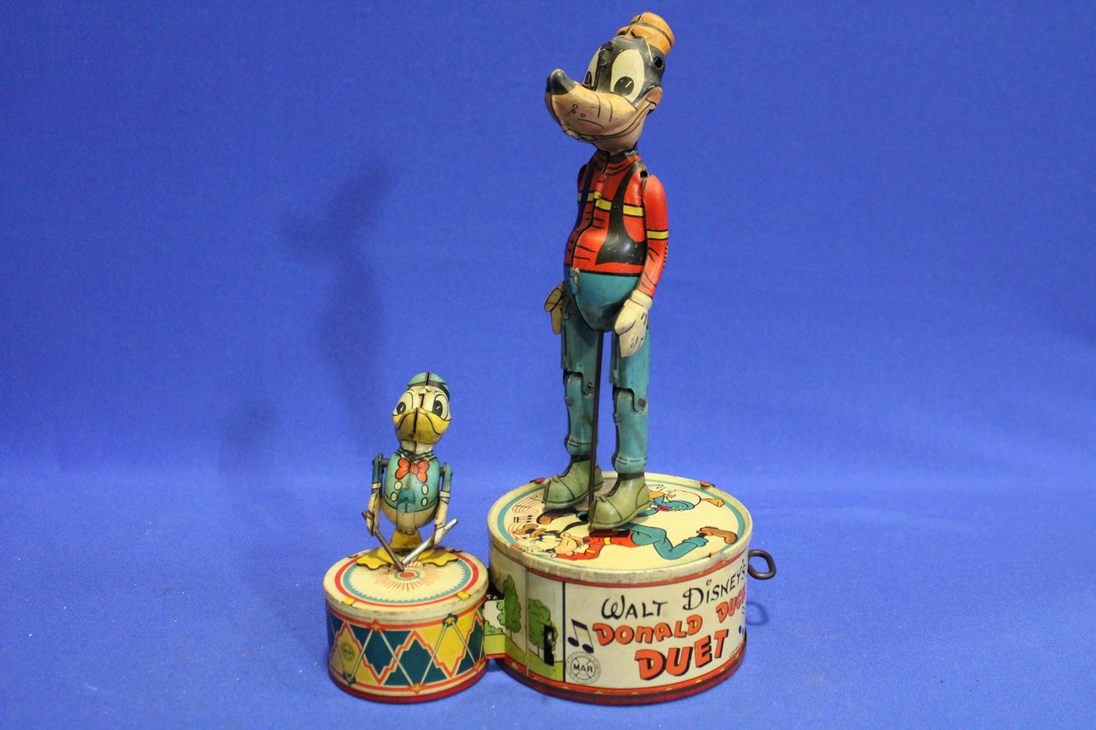 1946 Walt Disney Donald Duck Duo Tin Toy Wind-Up by Marx: 1946 Walt Disney's Donald Duck & Goofy Duet Tin Toy Wind-Up by Marx - Goofy dances while Donald plays the drums, 10" H, working.