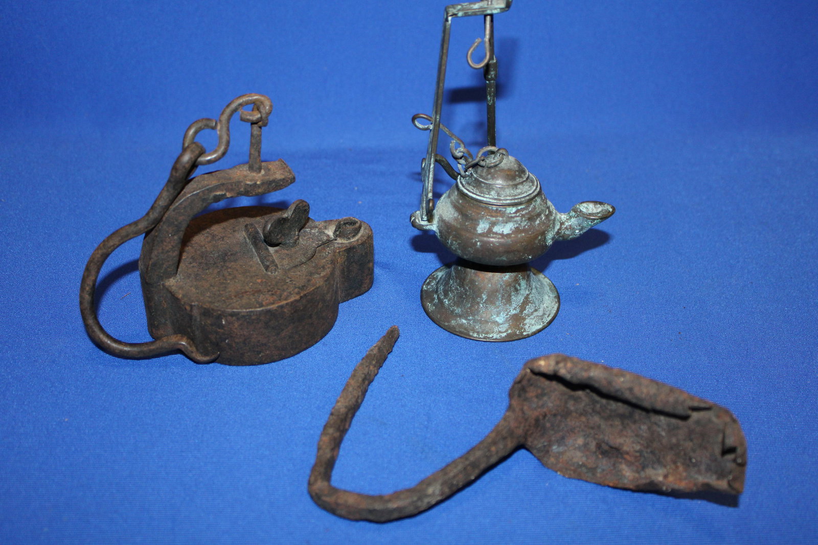 Early Iron Betty, Pan & Copper Lamps: Early Iron Betty Lamps - 1) heavy iron lamp with original hinge, lid filler turn key working, 4 1/4" L; 2) copper betty hang or stand lamp, 6 3/4" H; 3) forged iron pan lamp with sticking tommy-like c