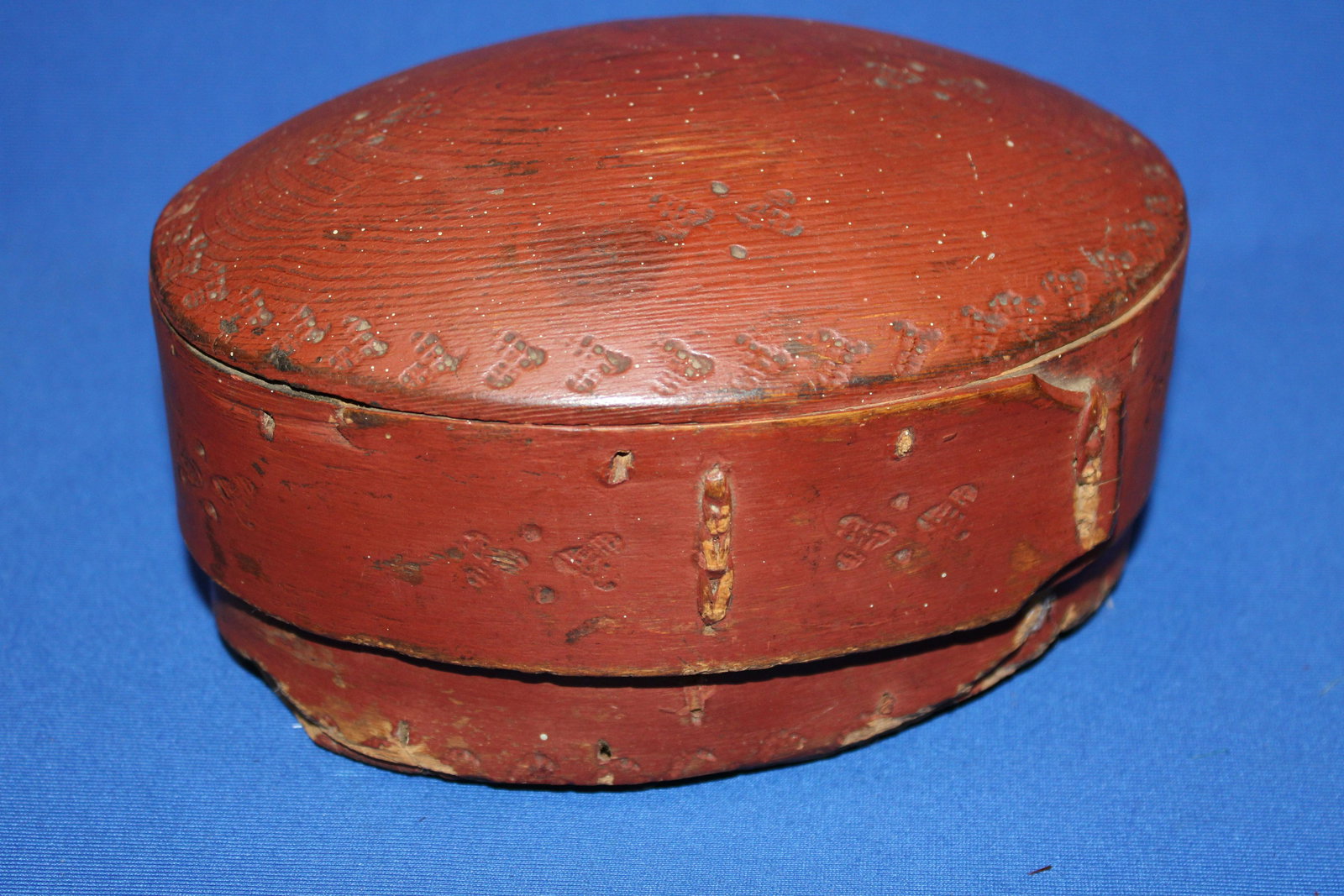 Red Oval Painted Pantry Box w/ Humped Lid & Laced Laps: Red Oval Painted Pantry Box w/ Humped Lid & Laced Finger Laps - possibly oak, decorative punched dots, 8" L x 4 1/2" H. See photos for condition.