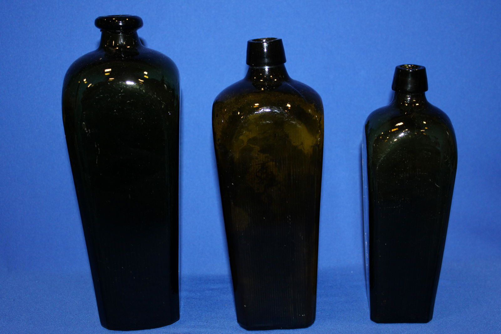 18th to 19th C Olive Green Bottles: 18th to Early 19th C Olive Green Bottles - tallest 11 3/4" H with rare flared donut form / round lip; 10 1/2; 9 1/2"; smallest 8 1/4" H. No issues.