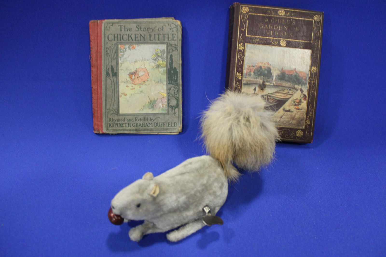 Tin Wind-Up Squirrel and 2 Child's Books: Tin Wind-Up Squirrel and 2 Child's Books - 7" L velvet wind-up squirrel, working; 1921 child's book, The Story of Chicken Little; A Child's Garden of Verses, Robert Lewis Stevehson.