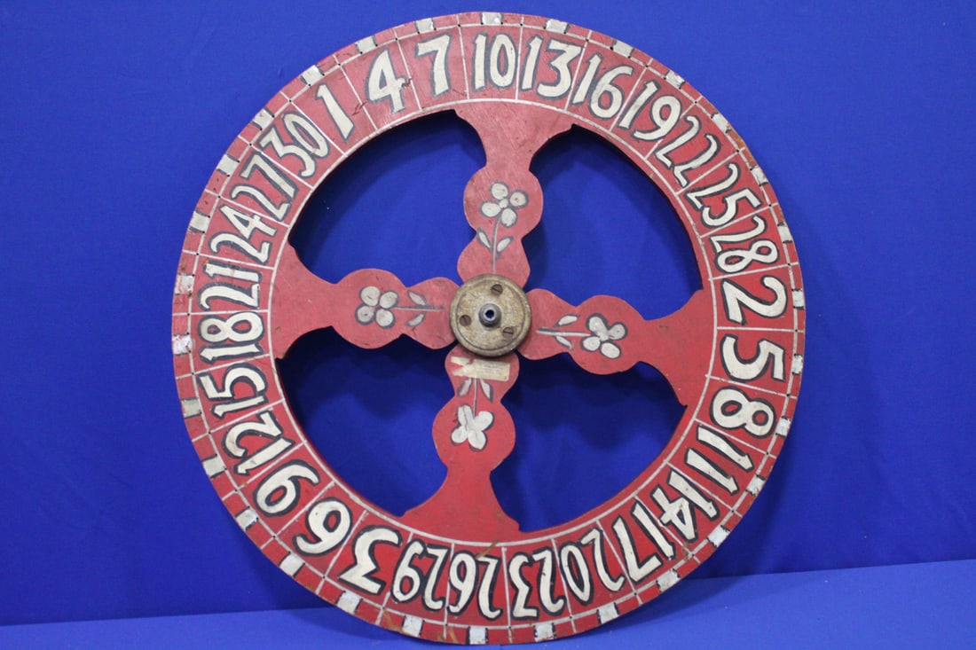 Wooden Folk Art Painted Carnival Gaming Wheel: Wooden Folk Art Painted Carnival Gaming Wheel - double-sided, attached old label attributing it to Doc Irving's Carnival, Philadelphia, lacking original pin stops, 23 1/2" W.
