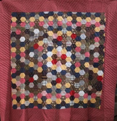 Multi-Colored Honeycomb Hexagon Quilt: Multi-Colored Honeycomb Hexagon Quilt - wide red printed fabric border, hand-stitched, brown printed coordinating fabric backing, 81 x 81. No issues.