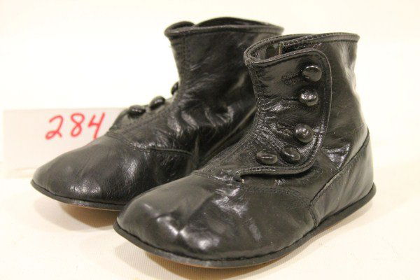 Baby's High Topped Button Shoes "Cupid" Unused: Baby's High Topped Button Shoes "Cupid" Unused; shiny, leather soles, impressed "Cupid" on leather soles, 5 3/4" long