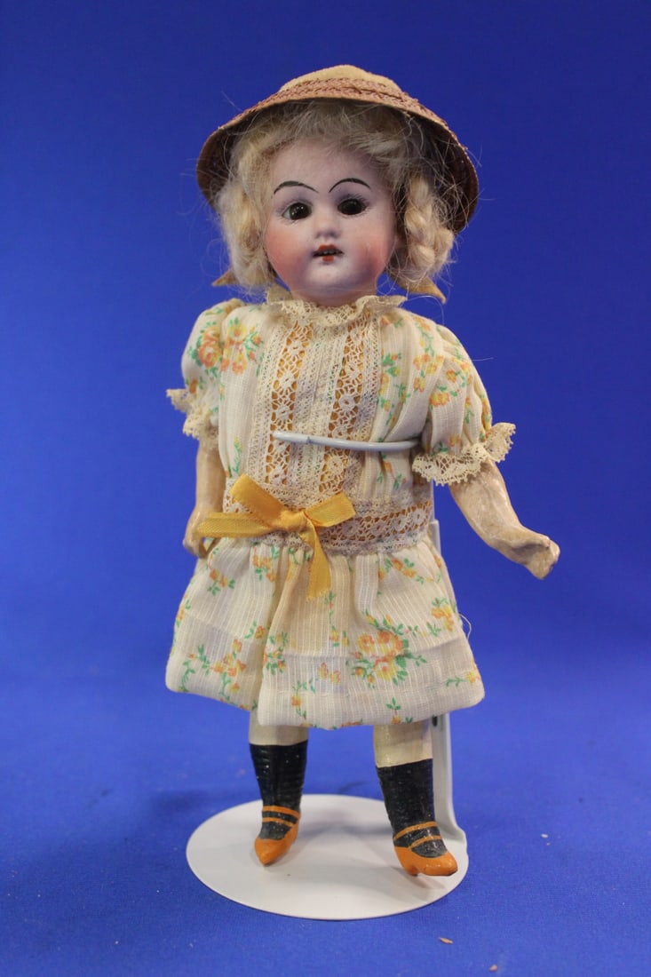 Early 20th D German Bisque Head Doll 193: Early 20th C German Bisque Head Doll 193 - socket head, brown fixed glass eyes, OM with teeth, braided blonde mohair wig, compo body, pink floral dress, painted shoes & socks, 8” H, no visible i
