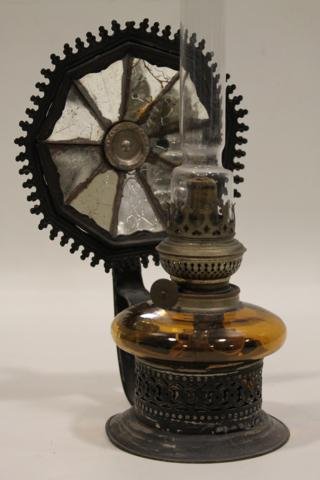 1800s Kosmos Brenner Tin Oil Lamp: Amber glass font, mirrored reflector, stands on table, hangs on wall or has handle for carrying, signed Kosmos Brenner