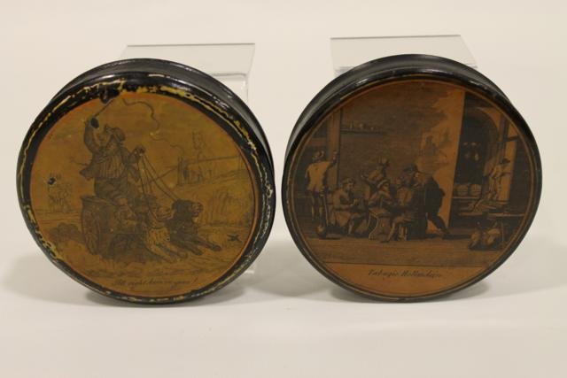 Pair Papier Mache Snuff Boxes: Early 1800s, round boxes, scenes of man with two dogs pulling cart "All right here ve go" with an old newspaper lining dated 1849; village people scene, both 3 1/2" accros.