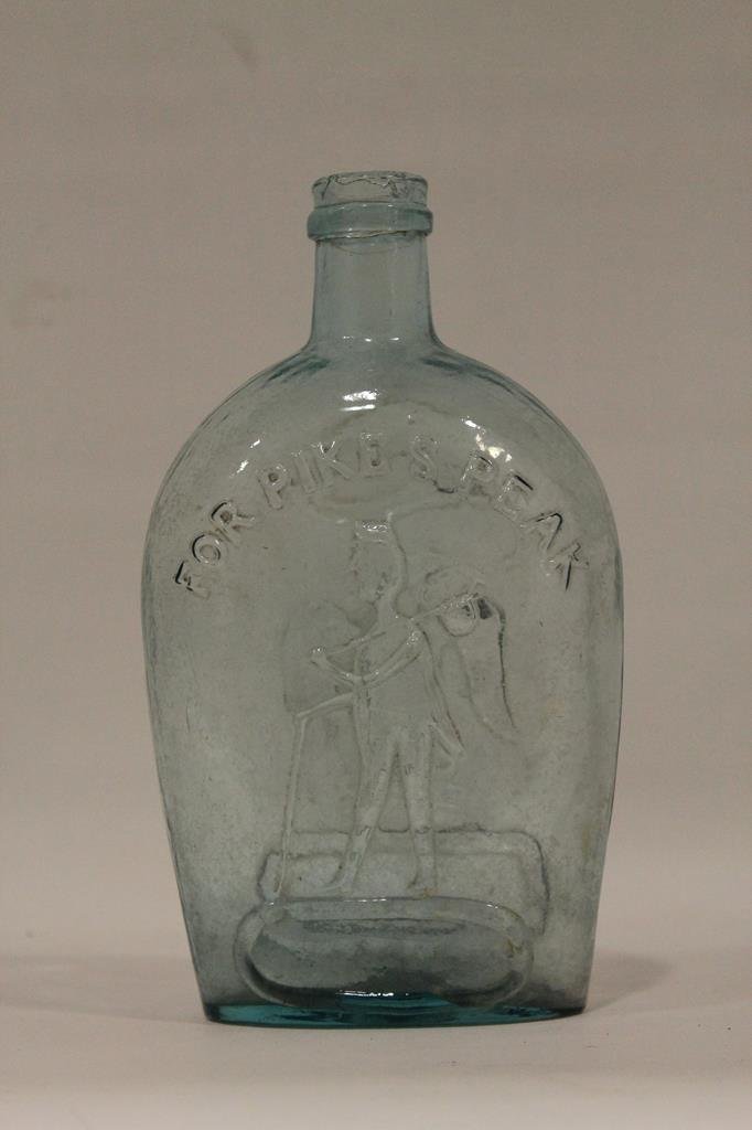 Pike's Peak Historical Flask / Bottle: Molded flask / bottle, 1870s, pale aqua pint flask with embossed "FOR PIKE'S PEAK" with a miner carrying his tools, reverse with eagle with banner and shield, applied ring lip, 7 1/2 H.