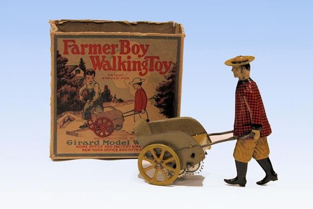 Girard Tin Wind-Up with Original Box: Girard "Farmer Boy Walking Toy", original graphic box, boy pushing cart with good decals, "Woods Mechanical Toys", tin wind-up, lithographed, "He cannot talk but can actually walk", "Girard Model Work