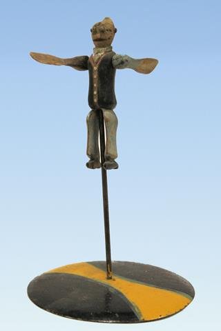 1900s Folk Art Jiggs Character Whirligig: Early 1900s hand-carved folk art whirligig cartoon bug-eyed character Jiggs on weighted metal stand, 7" H.