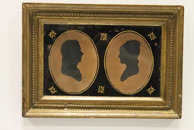 Cut Silhouettes Couple in Eglomise Frame: Cut silhouettes of couple in oval eglomise glass, gold gilded original frame, 7 1/4".