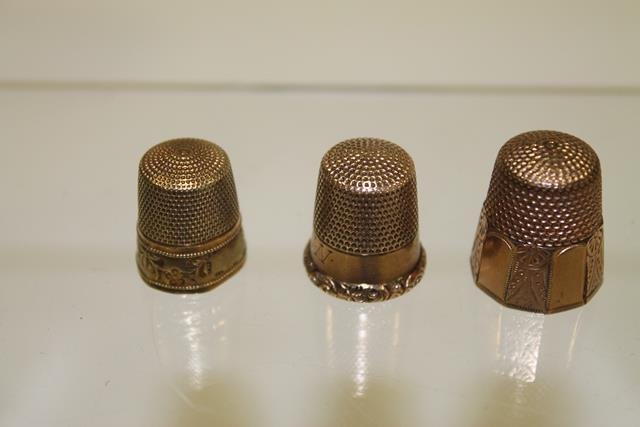 3 Gold Thimbles: 3 gold thimbles - 14K; 10K Star hallmark; one marked but illegible. Note: This lot is part of a large 35 lot Victorian sewing collection selling in this auction.