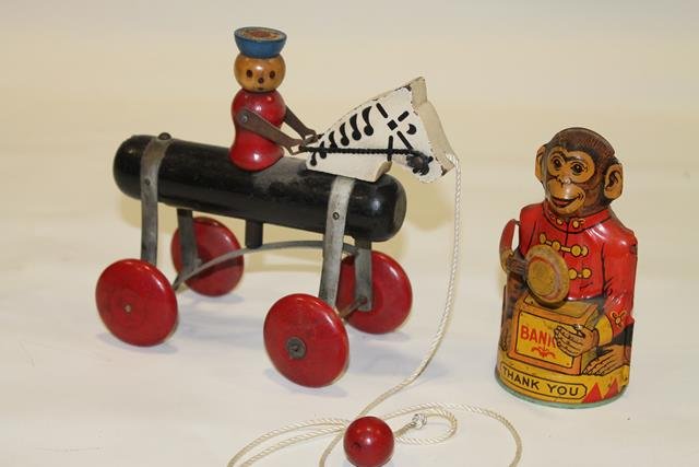 Chein Monkey Mechanical Bank: Chein tin lithographed monkey bank, 5" H. and The Toy Tinkers Inc. wooden horse and rider, 6 1/4" H.