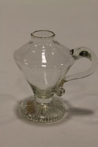 Flint Glass Miniature Whale Oil Lamp: Early 19th century flint glass Minature whale oil finger lamp, footed night light, applied handle, 3 3/4" H.