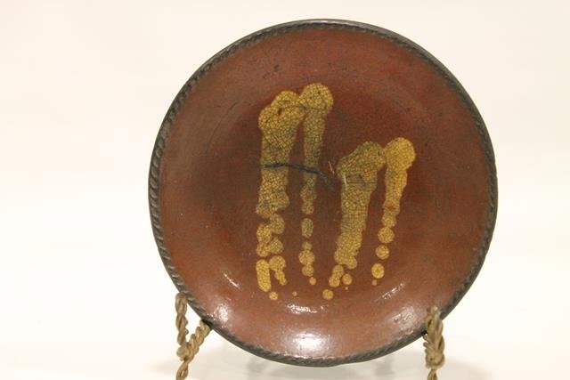 Pennsylvania Redware 8" Pie Plate: Redware pie plate, coggle edging, Pennsylvania, interior with four bands of yellow slip decoration, shiny, clear lead-glazed surface, 8" W.