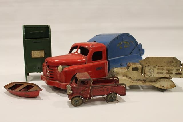 1930s Marx, Structo and Arcade Toys: 1930s Marx Motor Market stake truck; Marx row boat; Arcade cast iron ice truck, 7" L; 1940s Structo City of Toyland dump truck, hood opens up to reveal motor, 21" L.