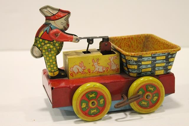 Wyandotte Easter Rabbit RR Hand Cart: Railroad tin wind-up handcart with Easter rabbit, lithographed, Happy Easter on front of cart, signed Wyandotte, 7" L.