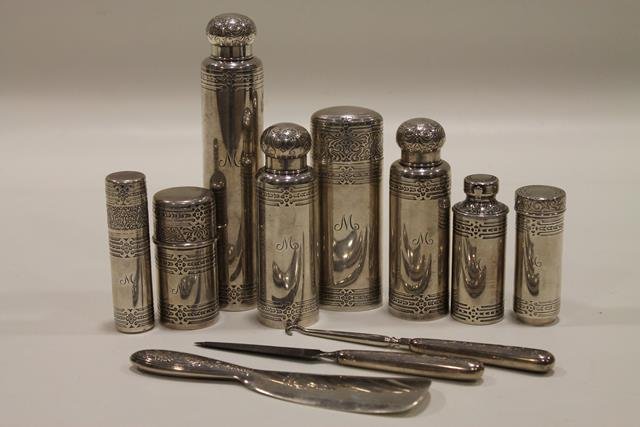 1900s Tiffany Sterling Traveling / Vanity Set: 11 piece matched set, early 1900s, 858 grams (plus file and button hook) each piece signed and numbered, monogramed "M", shoehorn, nail file, shoe button hook, 3 screw top colognes, tallest, 7" H, ova