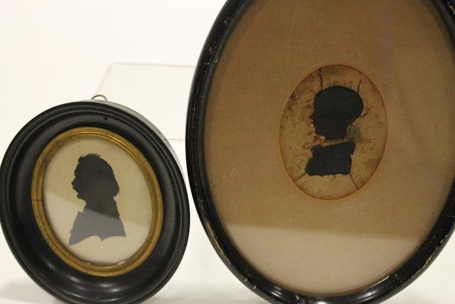 Pair Oval Silhouettes Child & Gentleman: Cut and pasted portrait silhouette of gentleman in ebonized frame, signed illegibly on reverse, 4 1/2" H; small child hollowcut, ebonized frame, 7 1/2" H.
