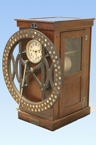 Early 1900s IBM Oak Time Clock: Quarter sawn oak case, 28" cast iron wheel on front to indicate employee number, 35" H.