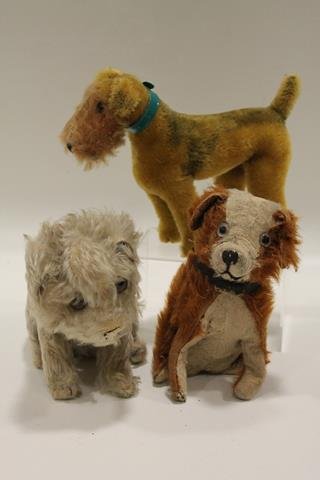 3 Plush Mohair Dogs: Plush Airedale with glass eyes, green plastic collar, painted mohair spots, 7" H; long blond mohair dog, glass eyes, 6 1/2" H; early straw-stuffed mohair brown and white dog, glass eyes, wired legs, 6