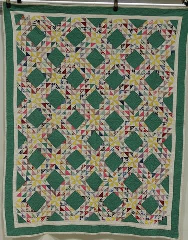 1920-40s Ocean Waves Crib Quilt: Green border, green squares with multi-colored printed triangle pieces, 50" x 63"