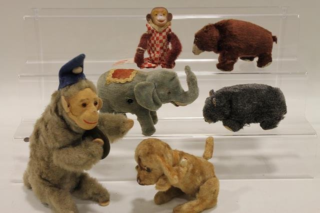 7 Wind-up Faux Fur Animals c.1940-50s: Flip over monkey, 4 1/2" H; 2 Sosco bears, 6" L; begging blond puppy, 6" H; Made in Japan elephant, 4" H; monkey with cymbal, 8" H.