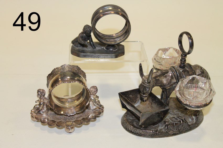 3 Figural Napkin Rings: Three silverplate napkin rings, two angels, one burrow at feeding trough.