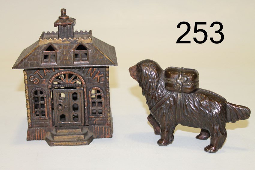 2 Cast Iron Still Banks "State Bank" Buildings: Pair cast iron still banks, "State Bank", Kenton, 1900, 4 5/8 x 3 1/2. "St. Bernard with Pack", A C Williams, 1905-1930s;
