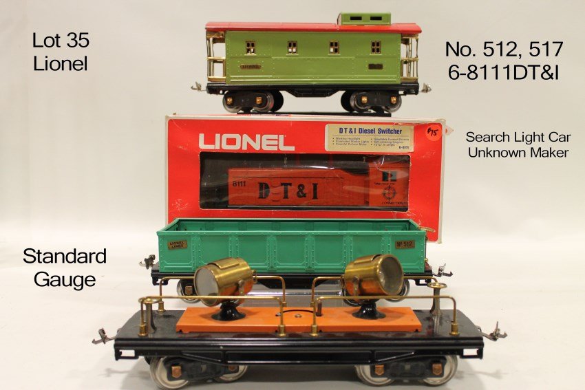4 Lionel Standard Gauge Train Cars - Reissues /: 512 with tag that says professionally restored attached to bottom; 517 green and red caboose; 6-8111DT & I diesel switcher in box; unknown maker double search light flat bed car.