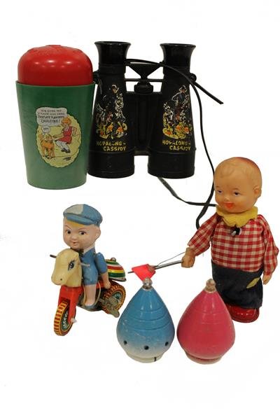 Group 1920-40s Toys: Hopalong Cassidy binoculars; Little Orphan Annie Ovaltine shaker mug; tin wind-up boy swatting fly; tin wind-up boy on horse-head tricycle; 2 Duncan spinning tops. Condition - working, boy on bike wit