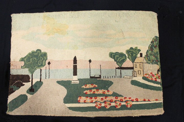 Hooked Rug - Swampscott Massachusetts Lighthouse: Hooked rug entitled "Monument Square Swampscott Massachusetts" depicting Monument Square with a lighthouse, seashore, buildings, 19th century, 36 x 26". Condition: light soil, staining.