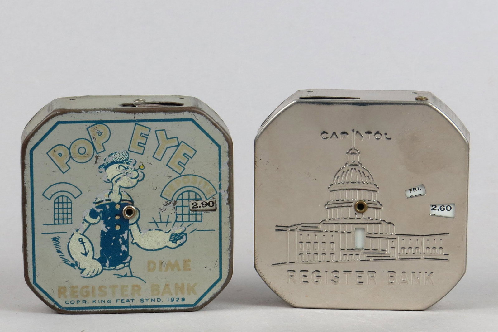 Lot of 2 Tin Dime Reg. Banks: 2 Dime Reg. Banks, Tin: "Popeye Dime Register Bank", dated 1929, VG; "Capitol Register Bank", Mint