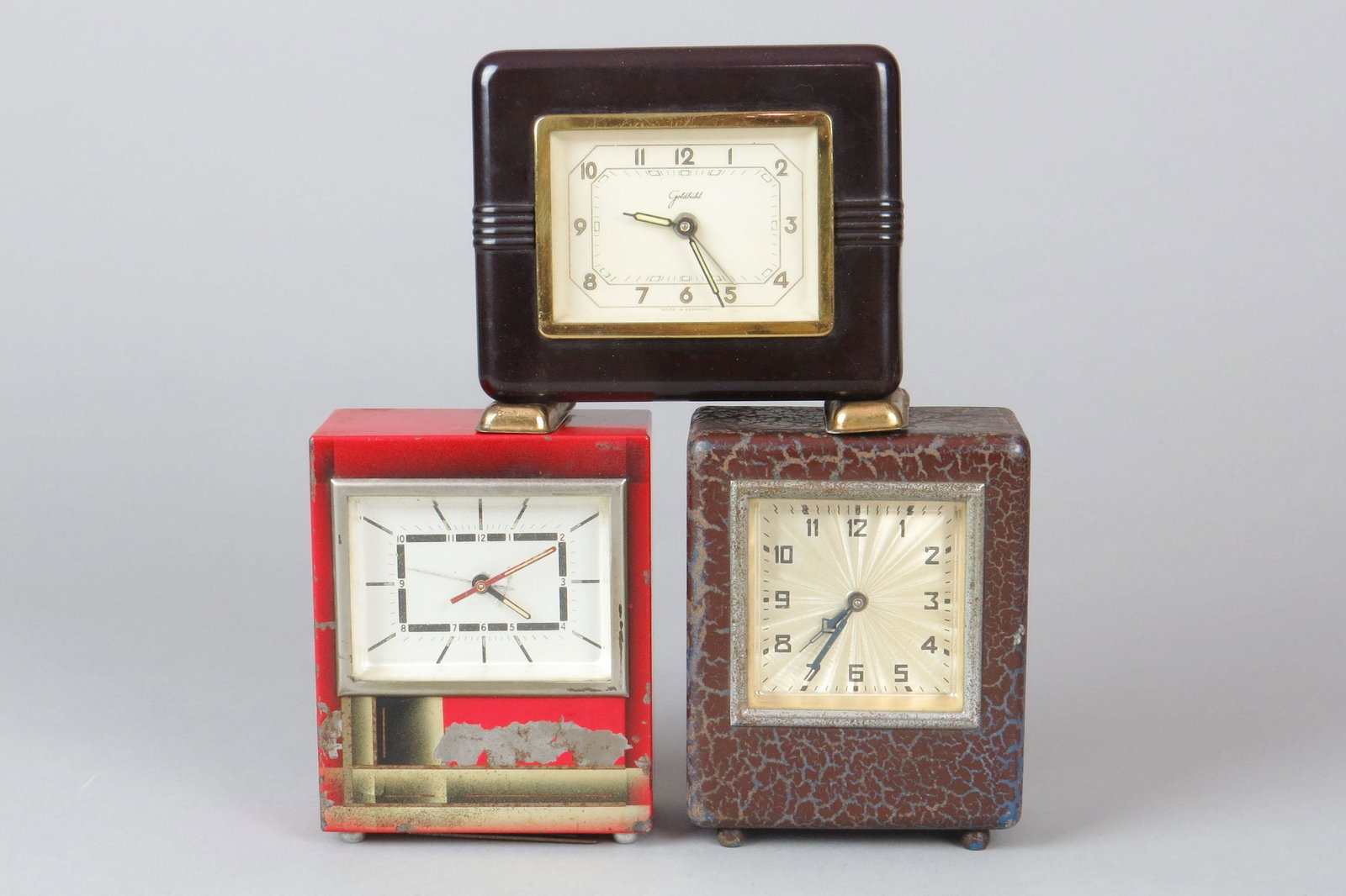 Lot of 3 Metal/Glass German Clock Banks: 3 German Clock Banks, Metal/Glass: Brown; Red, damage to front and missing lock; Marbled