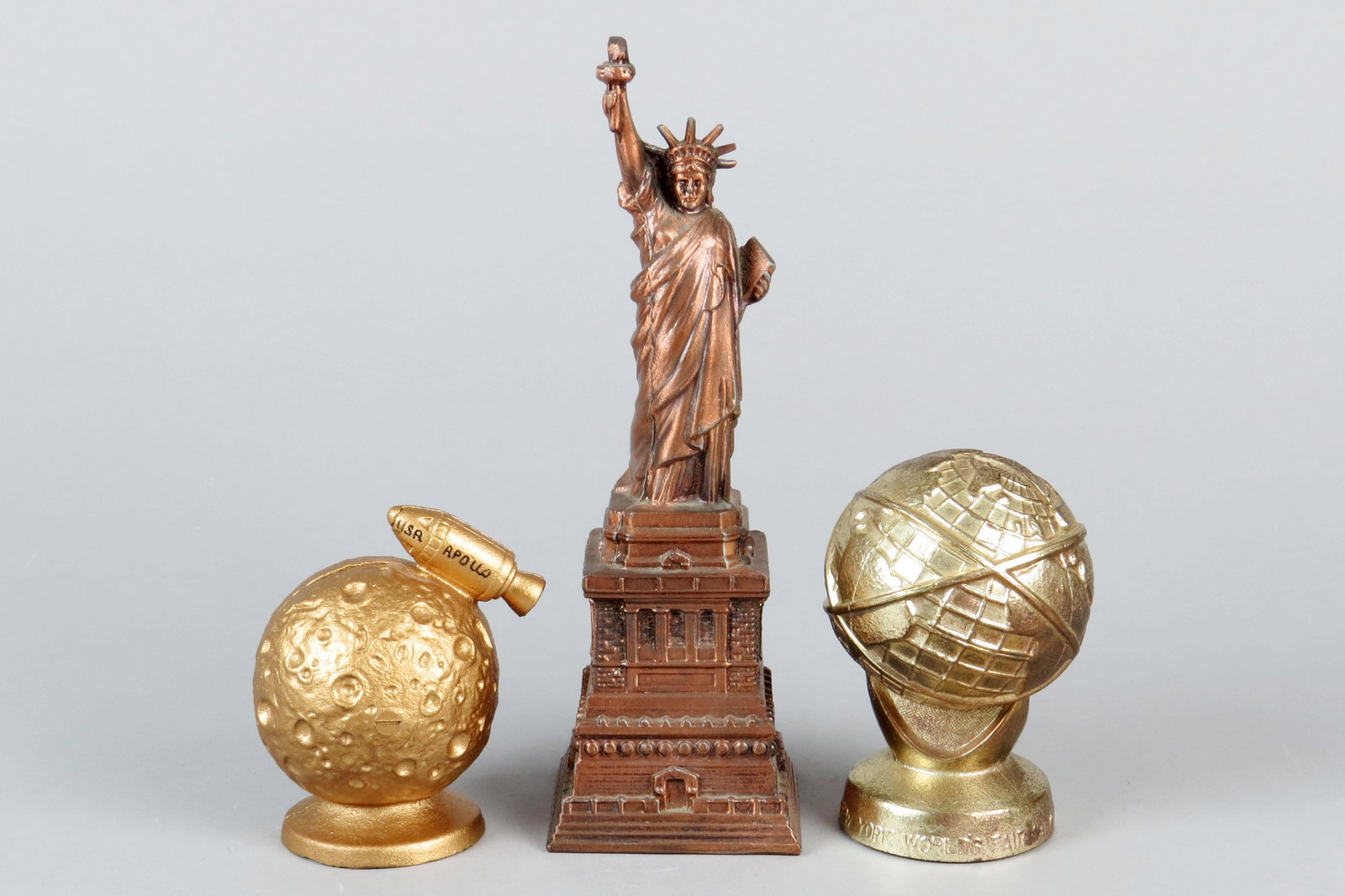 Lot of 3 PM/CI Misc. Banks: 3 Misc. Banks, PM/CI: "Apollo USA" Moon and Rocket; Statue of Liberty w/key; "New York's World Fair 1964-1965"