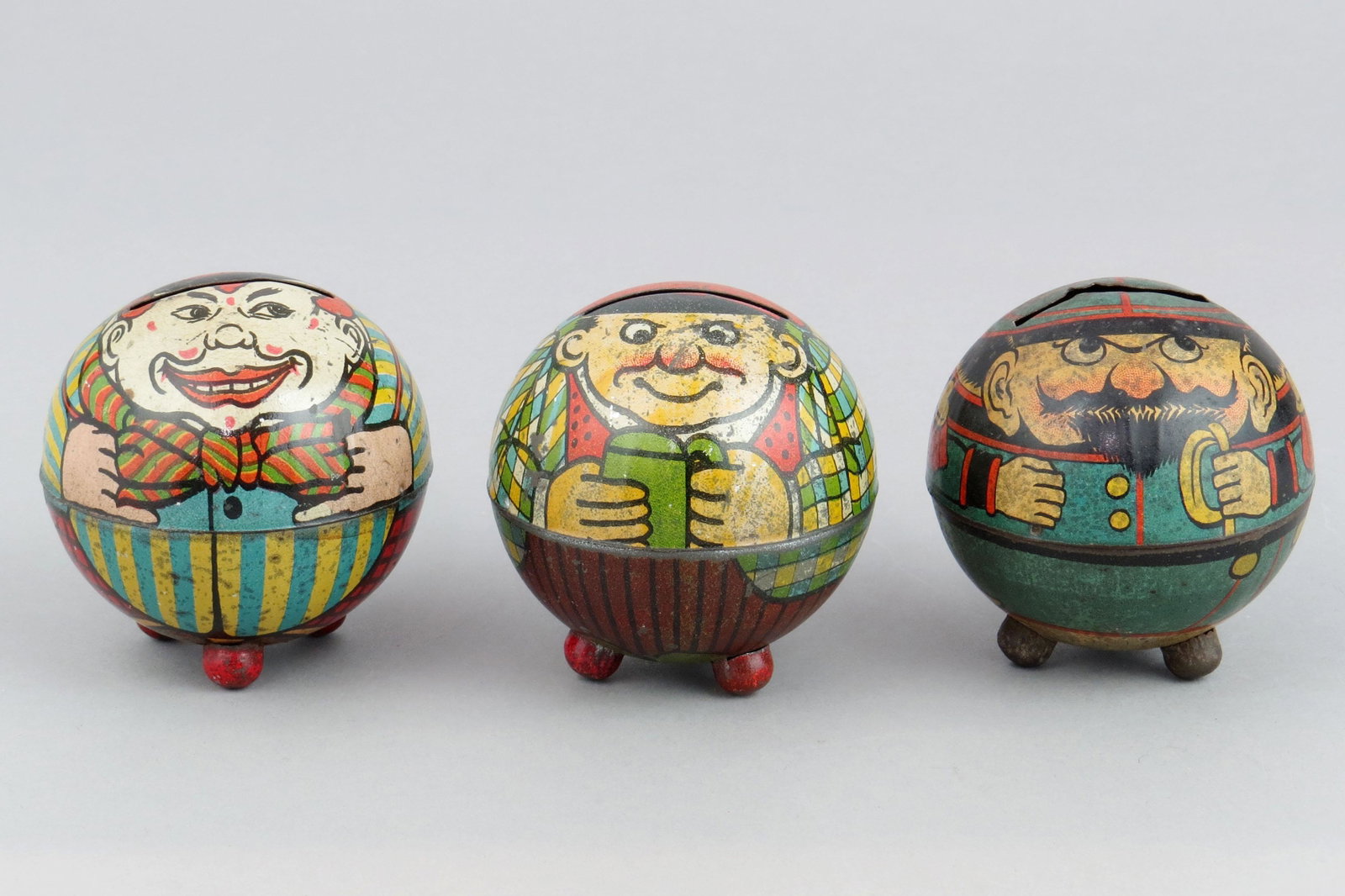 Lot of 3 Tin Round Characters on Ball Feet Banks: 3 Round Characters on Ball Feet Banks, Tin: Clown, M277; Man w/Mug, M N/L; Policeman, M271