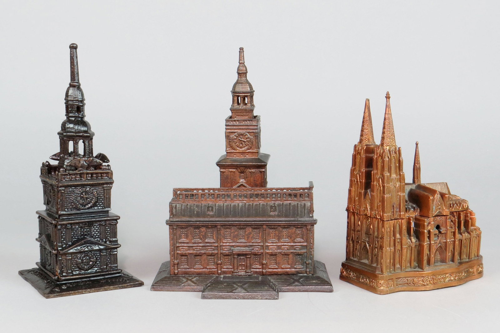 Lot of 3 CI/Lead Misc. Buildings: 3 Misc. Buildings, CI/Lead: "Tower Bank", Broken on one side above clock; Independence Hall, Small, Railing on side broken off; "Kolner Dom" Music Box, NOT A BANK, Hinge broken, bottom broken, one fin