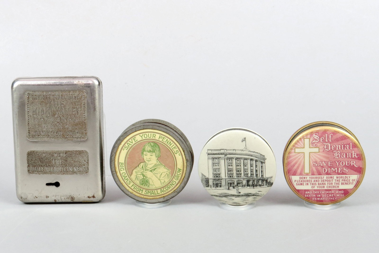 Lot of 4 Metal/Celluloid Pocket Banks: 4 Pocket Banks, Metal/Celluloid: "The Miami Valley National Bank, Hamilton, Ohio"; "Big Oaks From Small Acorns Grow"; "Christian Endeavor International Headquarters Building"; "Self Denial Bank, St. J