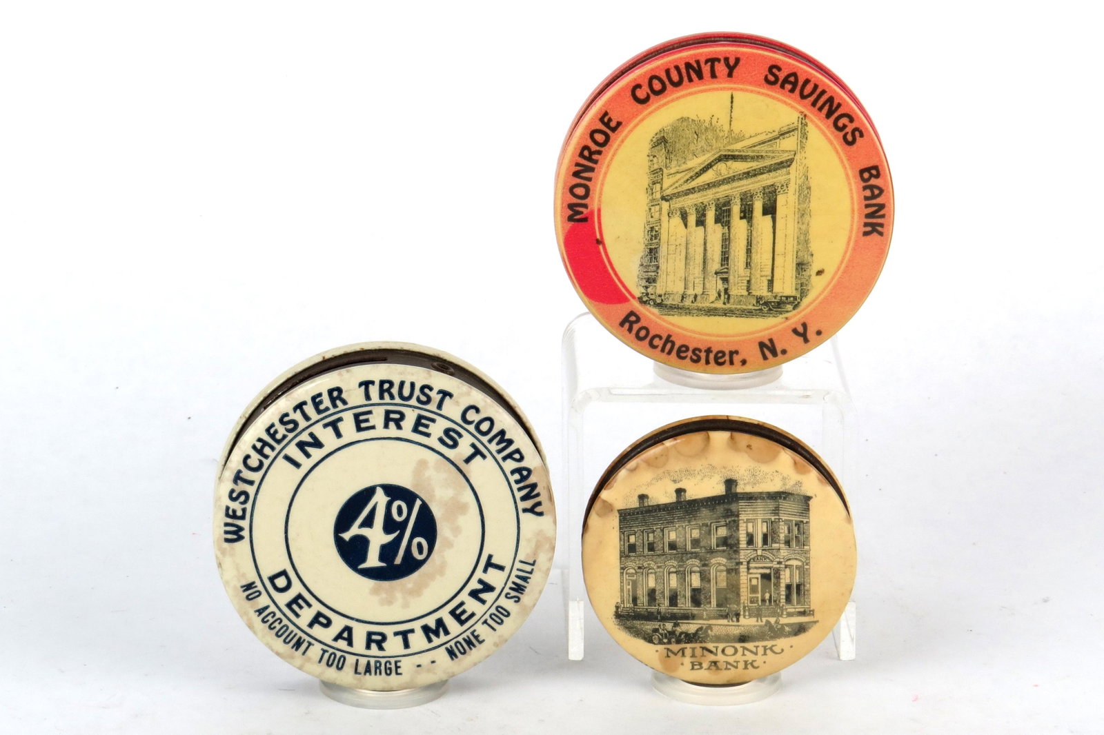 Lot of 3 Pocket Banks: 3 Pocket Banks, Celluloid: "Westchester Trust Company"; "Monroe County Savings Bank - Rochester, NY"; "Minonk Bank", Some staining
