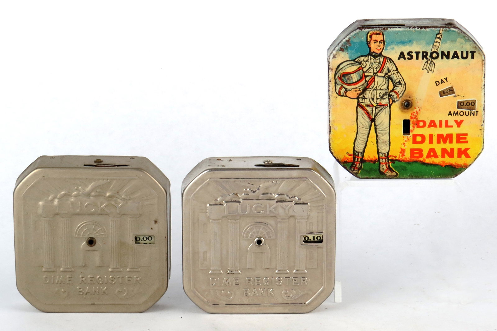 Lot of 3 Dime Register Banks: 3 Dime Register Banks, Tin: "Lucky Dime Register Bank"; "Lucky Dime Register Bank"; "Astronaut Daily Dime Bank"