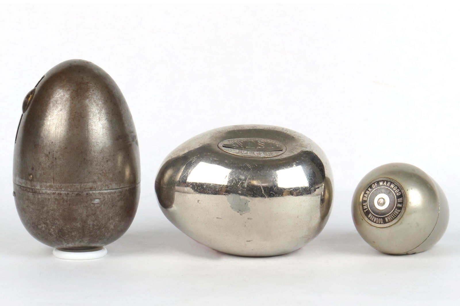 Lot of 3 Egg Banks: 3 Egg Banks, Silvered Metal: Largest, 3 3/8", Has key; "Nest Egg"; Smallest, 1 1/2"