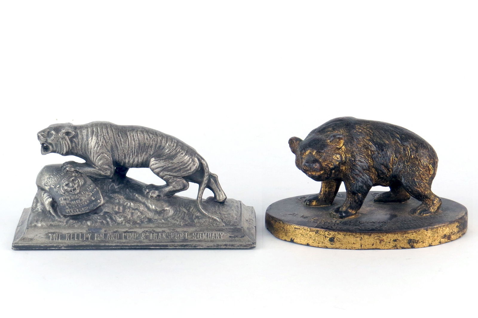 Lot of 2 Adv. Paperweights: 2 Adv. Paperweights, Lead: 4 3/4" long, "The Kelley Island Lime & Transport Co."; 4" long; "A. W. Bear Commission Co. - Butter Eggs Poultry"